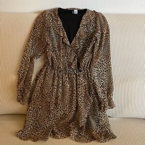 Animal print mini dress with ruffles along the neck sleeves and hem